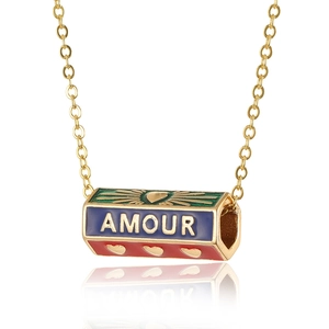 Detailed close-up of gold necklace with colorful enamel roller pendant and Amour text