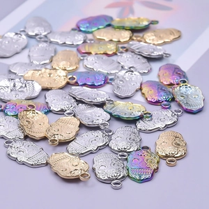 Macro detail of skull-shaped charms in gold, silver, and iridescent finishes for DIY jewelry