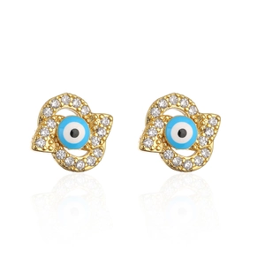 Macro detail of 18K gold plated Hamsa Hand earrings with zircon and blue evil eye inlay
