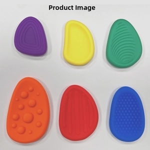 Detailed close-up of six colorful textured sensory stones made of soft silicone material