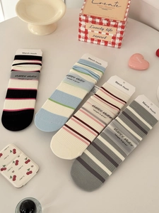 Detailed view of four pairs of striped cotton mid-calf socks in diverse pastel colorways