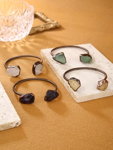 Detail of adjustable vintage bronze bracelets with raw amethyst and quartz stones