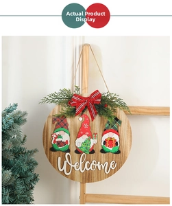 Detail of wooden Christmas welcome sign featuring Rudolph gnomes and festive pine needles