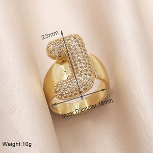 Macro shot of gold letter J ring with zircon inlay showing size and weight specs