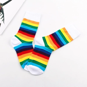 Detailed view of rainbow striped crew socks with white toe and heel on white background