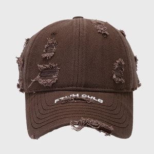 Close-up of distressed dark brown baseball cap with embroidery and frayed hole details