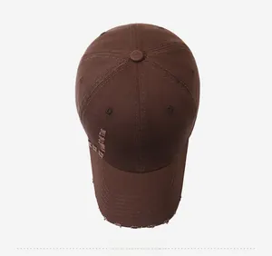 Top view of distressed dark brown cotton baseball cap with vintage frayed brim details