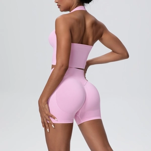 Detailed side-back view of pink seamless high-waist yoga shorts and halter sports bra