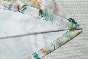 Detail shot of double-needle stitching on the printed hem and abstract marble pattern