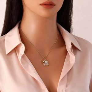 Golden elephant pendant necklace with white enamel inlay and sparkling rhinestones for women