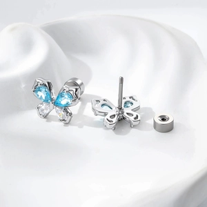 Silver butterfly earrings with blue and clear zircons shown from front and back views