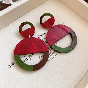 Detailed macro view of geometric resin drop earrings featuring marbleized color blocks