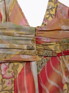 Detail view of Bohemian floral print midi dress featuring V-neckline and pleats
