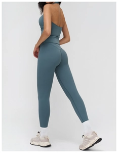 Detail view of the gray-blue backless halter yoga top and high-waist lifting leggings