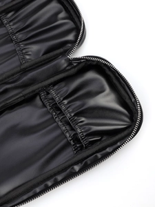 Detail of black PU makeup brush bag featuring elastic slots and silver metal zipper closure