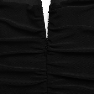 Close-up of black mesh fabric detail and invisible zipper on the sexy V-neck dress