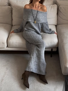 Detail of the gray ribbed knit fabric texture on an off-shoulder long-sleeved dress
