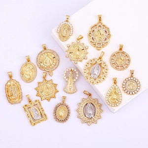Detailed close-up of 14K gold plated Virgin Mary religious pendants with cubic zirconia