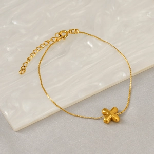 Close-up of golden stainless steel bracelet with chubby cross pendant and lobster clasp