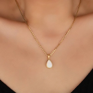 Elegant gold-plated waterdrop necklace with faux opal pendant worn by a female model