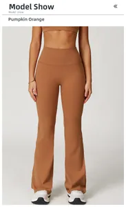 Detailed close-up of high-waist flared yoga pants in pumpkin orange performance fabric