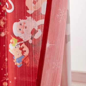 Detail of red Christmas curtain showing twill fabric texture and neat double stitching