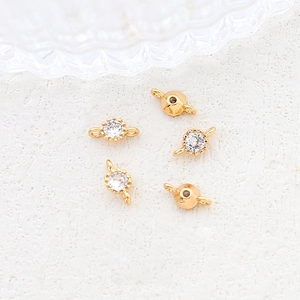 Macro shot of five gold-plated circular zircon connectors for DIY jewelry making and crafts