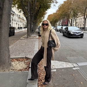 Oatmeal knit cardigan with scarf collar and brown wide-leg pants in autumn street style