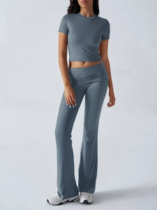Detail of blue-grey short sleeve crop top and high waist flared pants two-piece set
