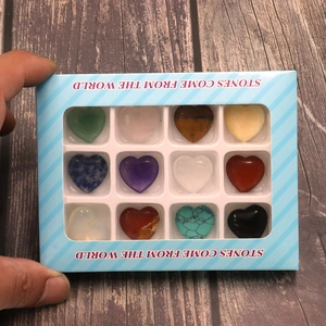 Detail showing twelve heart-shaped natural crystal stones in a blue window display box