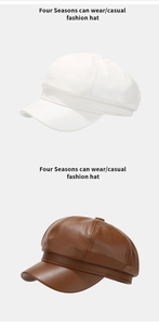 Detail view of stylish white and brown PU leather newsboy caps with textured finish