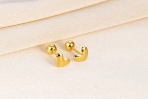 Detailed view of polished gold S925 silver heart stud earrings with secure screw backings