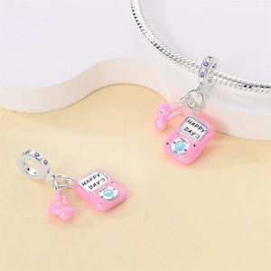 Detailed view of pink enamel MP3 player charm with bunny and purple zircon on silver bracelet
