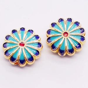 Close-up of alloy enamel sunflower beads with blue gradient and gold-plated edges