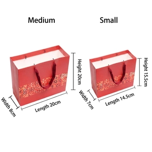 Red ethnic style paper gift bags with handles in medium and small sizes