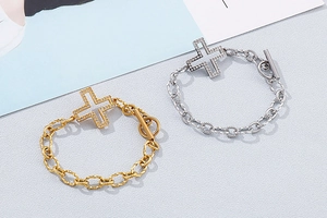 Detail of twisted chain bracelet with crystal cross pendant and OT toggle clasp