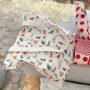Detailed view of white canvas tote bag with colorful cartoon dog illustrations and woven label