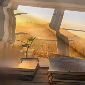 Detailed close-up of light gold translucent fabric with warm sunset lighting backdrop