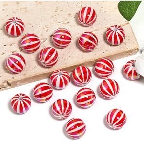 Macro shot of red and white striped UV coated pumpkin beads for DIY Christmas jewelry