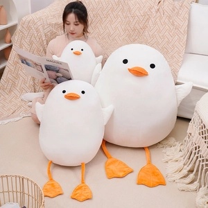 Cute white duck plush toy outer shells in various sizes shown in a cozy lifestyle setting
