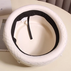 Detailed interior of 100% wool beret with white mesh veil and adjustable sweatband