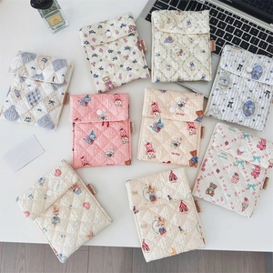 Flat lay of quilted sanitary pouch collection with cute bears and floral patterns