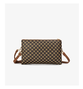 Detail of vintage patterned crossbody bag with gold-tone zipper and adjustable strap