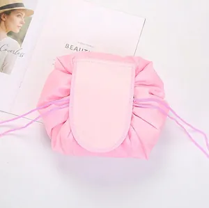 Detailed top view of pink drawstring makeup bag with velcro flap on white background