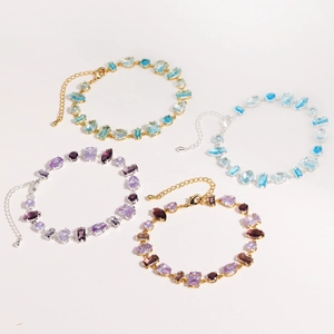 Elegant gold and silver bracelets with colorful zircon stones in a balanced layout