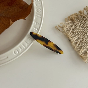Detail of a French tortoise shell resin hair clip with gold France Handmade lettering