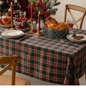 Detailed view of red and green plaid table runner with Christmas holiday table setting