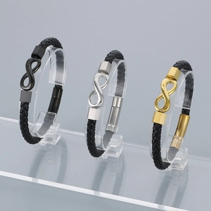 Detail of infinity charm bracelets with braided leather and magnetic steel clasps