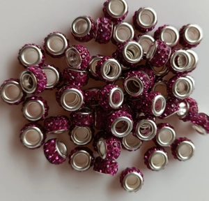 Close-up of pink rhinestone paved cylinder spacer beads with large inner holes