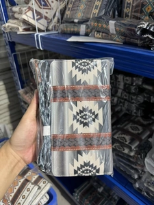 Detail of Bohemian style canvas clutch featuring tribal patterns and convenient wristlet